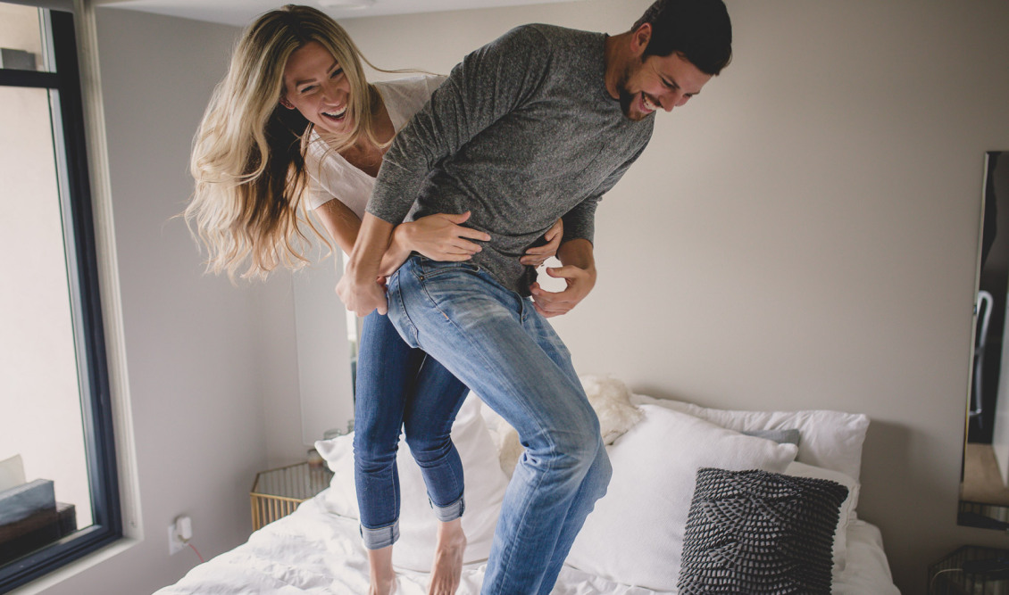 photo-of-couple-jumping-on-the-bed-by-Tami-Keehn