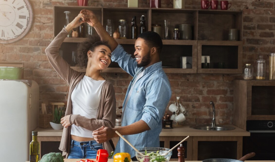 romantic-couple-dancing-in-kitchen-while-cooking-together